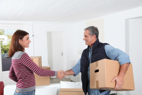 Professional movers carrying furniture in a Bayswater apartment building