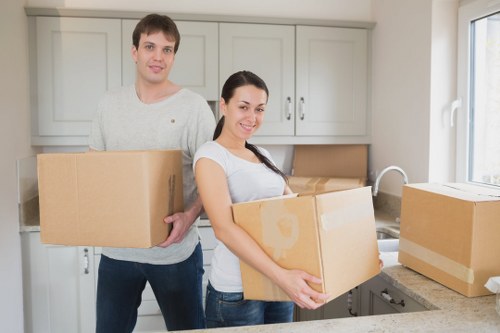 Two movers handling a heavy item carefully during a house move